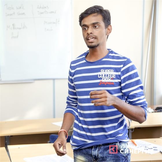 Sumeet explaining an idea to classmates at Synergy University, Russia